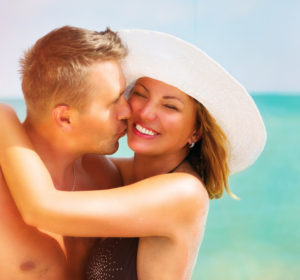 Middle aged couple enjoying romantic summer beach holidays.